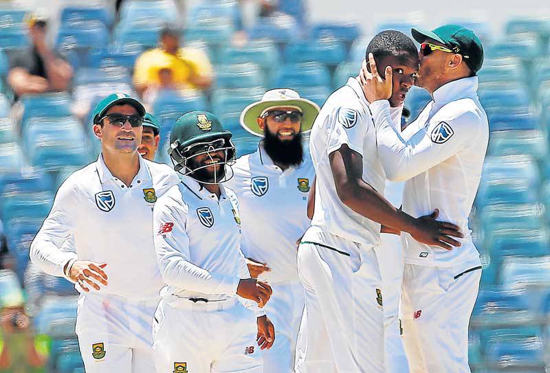 MAN OF THE MOMENT South Africa’s Kagiso Rabada is kissed by team captain Faf du Plessis as they celebrate dismissing Australia’s Mitchell Starc at the Waca Ground in Perth Australia yesterday. Rabada steered the Proteas to victory in the first of