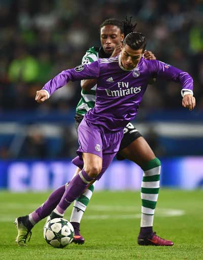 Real Madrid’s Portuguese forward Cristiano Ronaldo vies with Sporting’s defender Ruben Semedo during the UEFA Champions League football match Sporting CP vs Real Madrid CF at the Jose Alvalade stadium in Lisbon on Wednesday. AFP