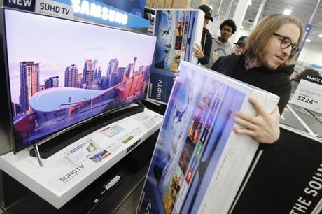 Joseph Rebelo grabs the television he waited in line for as he and fellow shoppers look for the best deals at Best Buy on Black Friday in Dartmouth Mass. Nov. 25 2016. Stores open their doors Friday for what is still one of the busiest days of the yea