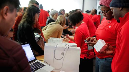 Cashiers work during Black Friday sales at the Apple Fifth Avenue store in New York