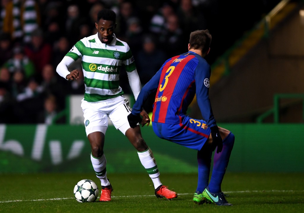 GLASGOW SCOTLAND- NOVEMBER 23 Moussa Dembele of Celtic attempts to take the ball past Gerard Pique of Barcelona during the UEFA Champions League Group C match between Celtic FC and FC Barcelona at Celtic Park Stadium