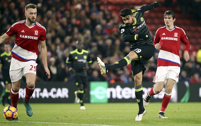 Chelsea's Diego Costa center has a shot towards goal past Middlesbrough's Callum Chambers left and Marten De Roon during their English Premier League match at the Riverside stadium Middlesbrough Sunday Nov. 20