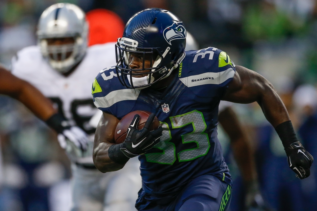 Running back Christine Michael #33 of the Seattle Seahawks rushes against the Oakland Raiders at Century Link Field