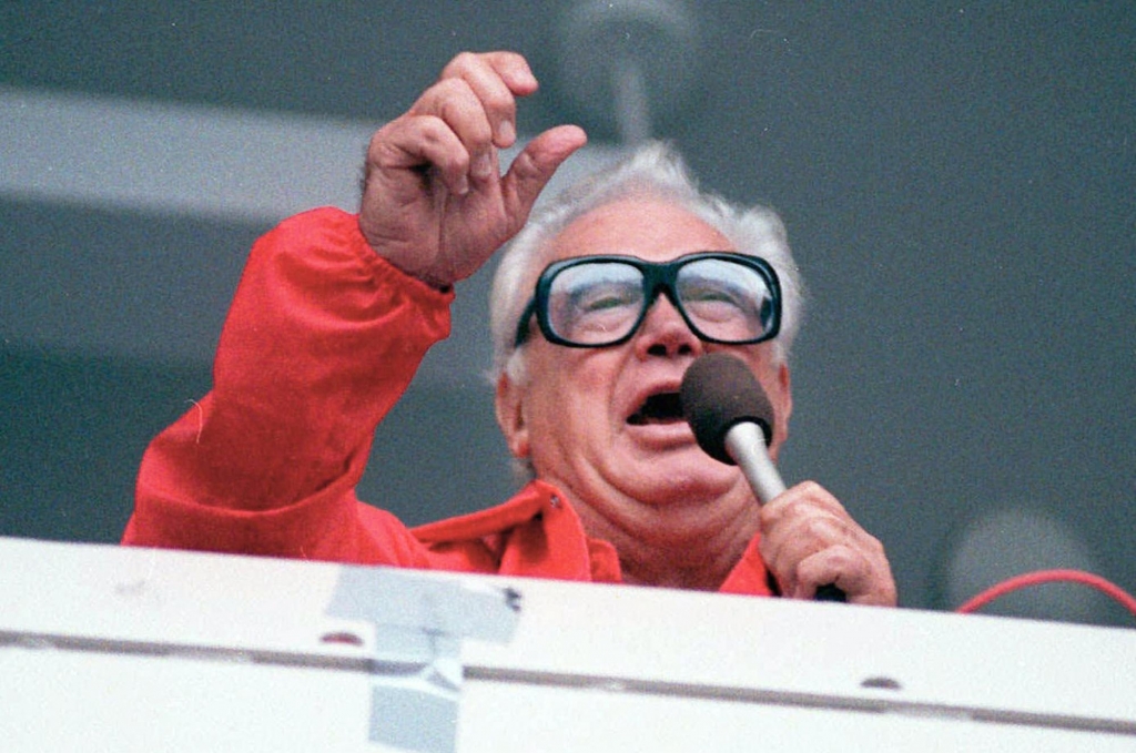 Chicago Cubs’ broadcaster Harry Caray sings “Take Me Out To The Ballgame” during the seventh inning stretch at Chicago’s Wrigley Field