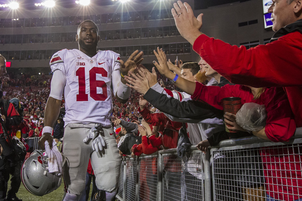 15 October 2016 The Ohio State Buckeyes quarterback J.T. Barrett celebrates with fans after the 2nd ranked Ohio State Buckeyes defeat the 8th ranked Wisconsin Badgers in overtime at Camp Randall Stadium in Madison WI