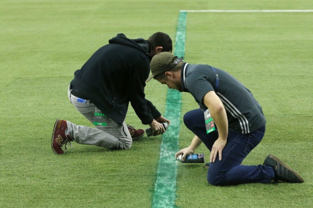 Impact grounds crew race to paint over lines for the penalty box that was too narrow at the MLS playoff game between TFC and Montreal Impact at Olympic Stadium in Montreal on Tuesday