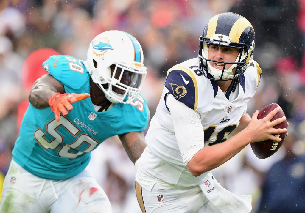 Quarterback Jared Goff #16 of the Los Angeles Rams scrambles from Andre Branch #50 of the Miami Dolphins before getting sacked in the second quarter of the game at Los Angeles Coliseum