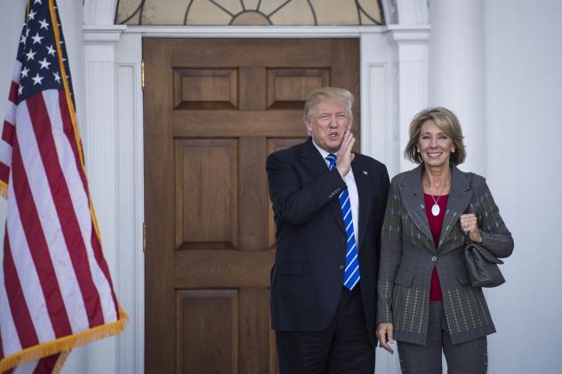 President-elect Donald Trump stands with Betsy De Vos after a meeting at Trump National Golf Club Bedminster in Bedminster Township N.J. on Saturday