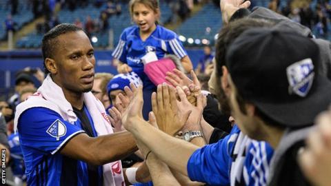 Didier Drogba greets the crowd