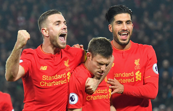 Liverpool's James Milner celebrates with teammates Jordan Henderson and Emre Can after scoring his side's second goal against Sunderland during their English Premier League match at Anfield in Liverpool Saturday. — AP