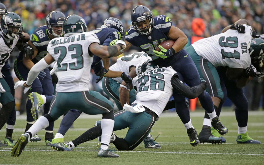 Seattle Seahawks running back Thomas Rawls center rushes against Philadelphia Eagles defensive back Jaylen Watkins and free safety Rodney Mc Leod in the second half of Sunday’s game