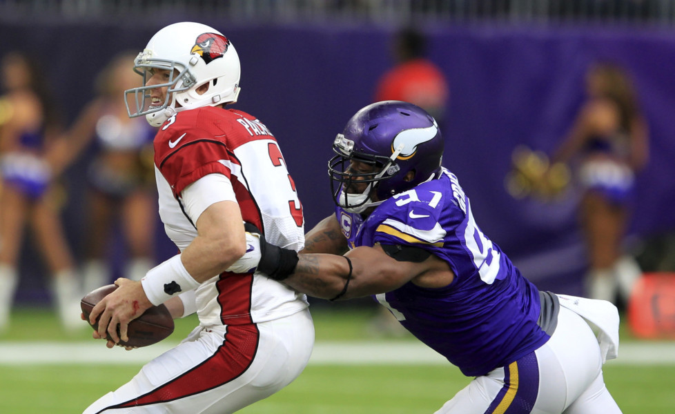 Arizona Cardinals quarterback Carson Palmer runs from Minnesota Vikings defensive end Everson Griffen right during the first half of an NFL football game Sunday Nov. 20 2016 in Minneapolis