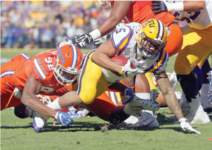 LSU RUNNING BACK Derrius Guice carries near the goal line as he is tackled by Florida defensive lineman Jabari Zuniga in the first half of Saturday’s SEC game in Baton Rouge La. The Gators stopped the Tigers on a pair of goal line plays