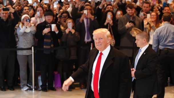 U.S. President-elect Donald Trump walks past a crowd as he leaves the New York Times building following a meeting New York U.S