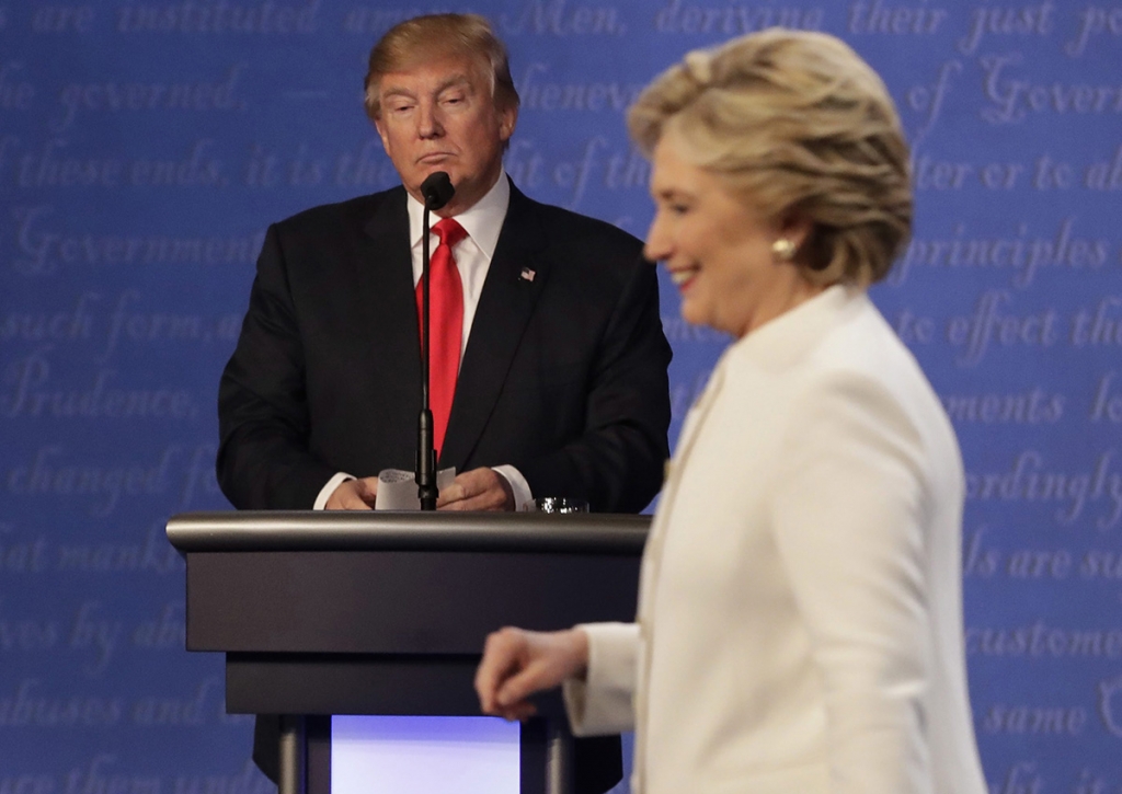 Republican presidential nominee Donald Trump waits behind his podium as Democratic presidential nominee Hillary Clinton makes her way off the stage following the third presidential debate at UNLV in Las Vegas