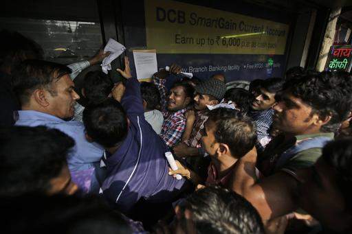 India struggles as millions throng banks to swap currency