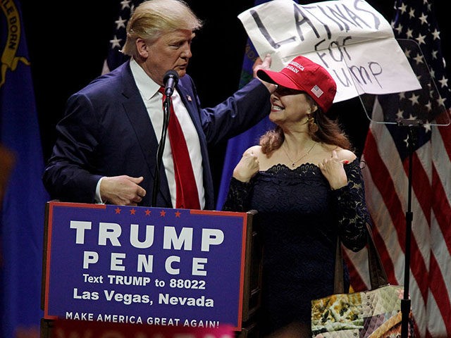 A Latino supporter speaks on stage with Republican presidential candidate Donald Trump during a campaign rally at the Venetian Hotel