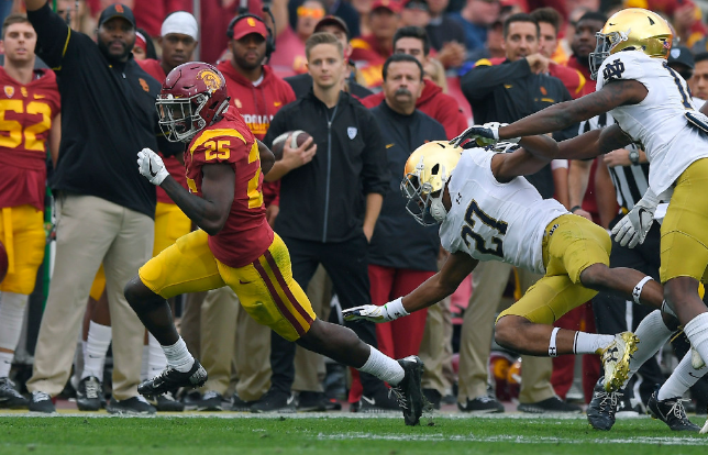 USC running back Ronald Jones II runs 51 yards for a touchdown past Notre Dame cornerback Julian Love and safety Devin Studstill on Saturday in Los Angeles. | Mark J. Terrill  AP