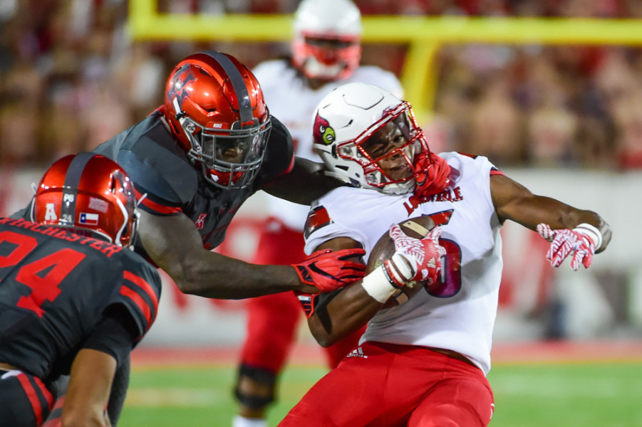 HOUSTON TX- NOVEMBER 17 Louisville Cardinals wide receiver Seth Dawkins is tackled high during second half action during the NCAA football game between the Louisville Cardinals and Houston Cougars