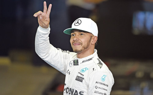 Lewis Hamilton gestures after taking pole position in the qualifying session on Saturday