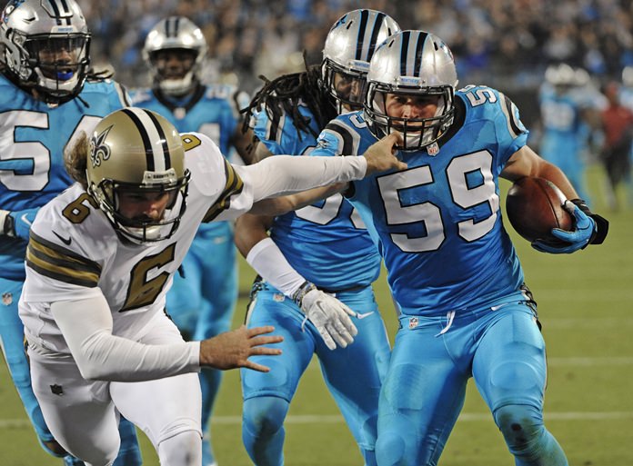 Carolina Panthers Luke Kuechly runs past New Orleans Saints Thomas Morstead as he returns a blocked field goal attempt in the first half of their NFL football game in Charlotte N.C. Thursday Nov. 17