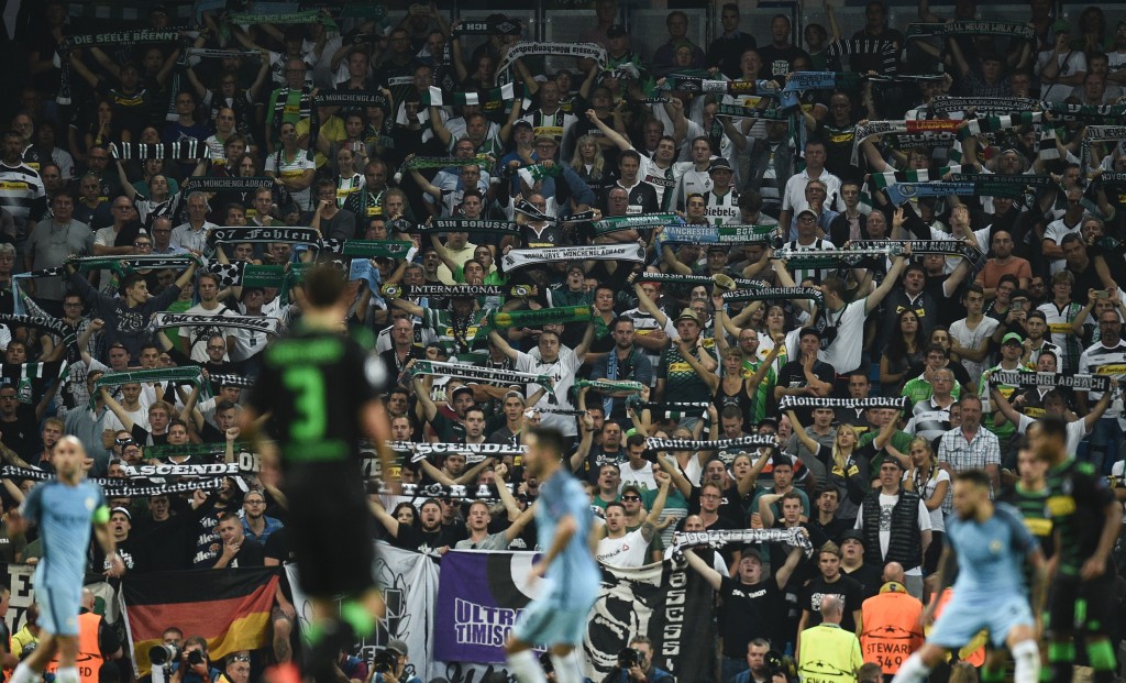 Monchengladbach fans hold up scarves during the UEFA Champions League group C football match between Manchester City and Borussia Monchengladbach at the Etihad stadium in Manchester northwest England