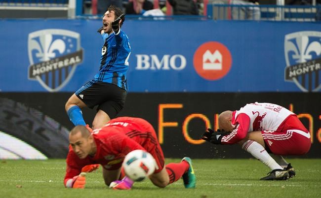 New York Red Bulls goalkeeper Luis Robles and Aurelien Collin right react as Montreal Impact's Matteo Mancosu celebrates after scoring during second half action of the first leg of the eastern conference MLS soccer semifinal in Montreal Sunday Oct