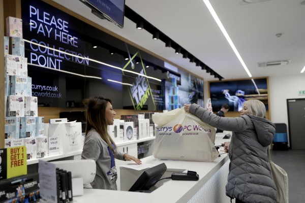 A customer picks up a carrier bag containing