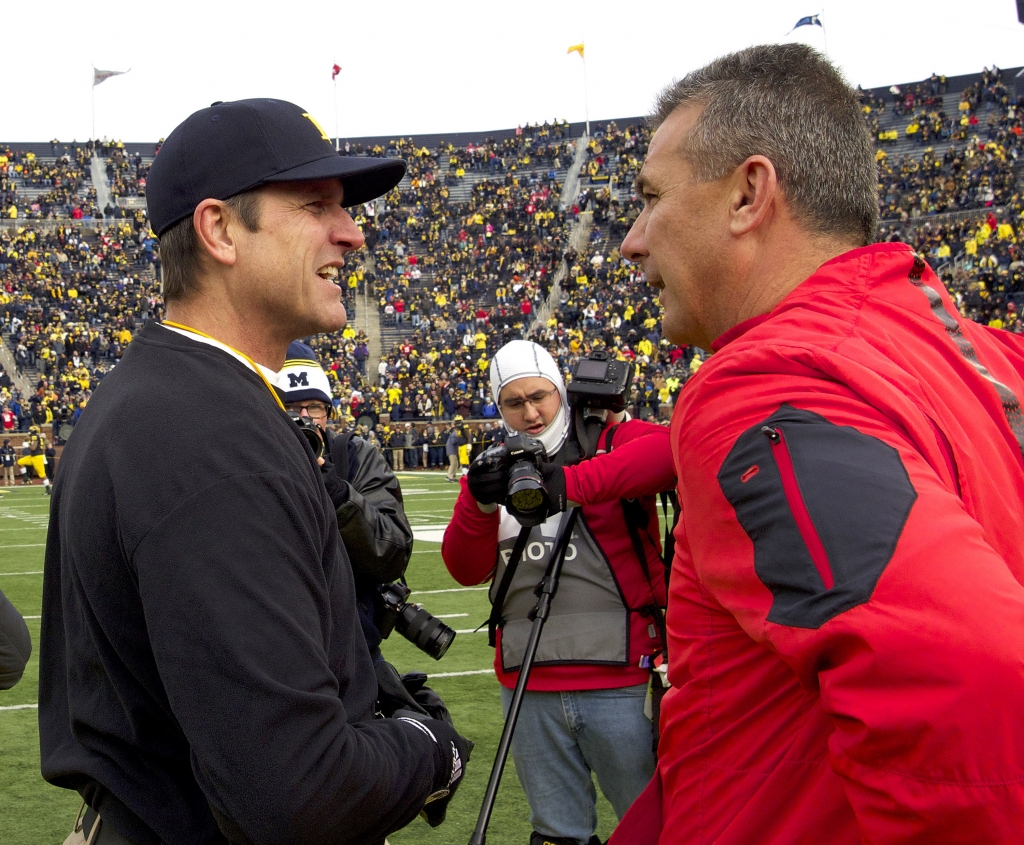 Michigan head coach Jim Harbaugh left greets Ohio State head coach Urban Meyer on the Michigan Stadium field before an NCAA college football game in Ann Arbor Mich. Harbaugh hopes to help Michigan upset Ohio St