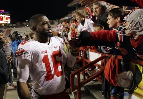 Ohio State quarterback J.T. Barrett greets fans after an NCAA college football game against Maryland in College Park Md. Saturday Nov. 12 2016