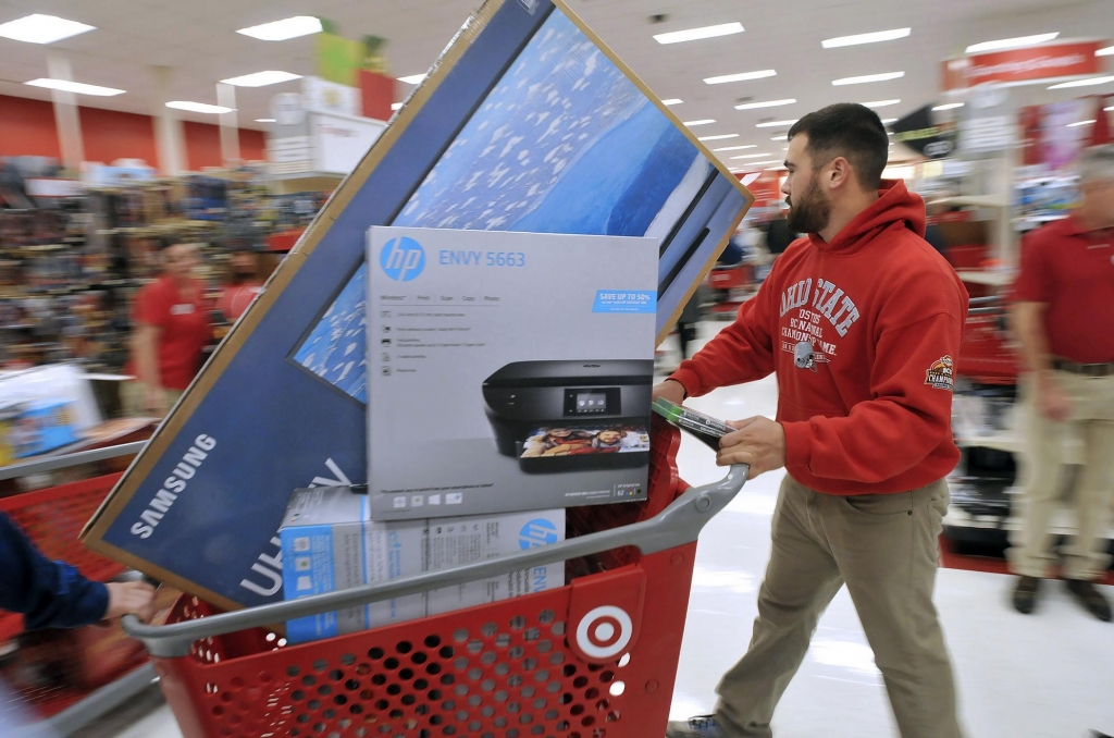 A man pushes his cart filled with appliances in the Target store in Plainville Mass. shortly after the store opened at 1 a.m. Friday