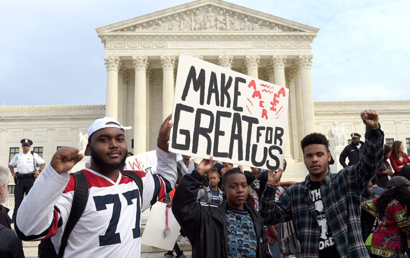 Hundreds of demonstrators are gathered outside the Supreme Court to protest Donald Trump’s election. They are mostly young people who appear to have walked out of school to protest