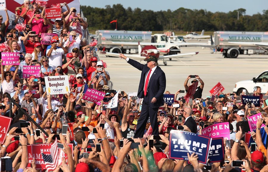 Donald Trump waves to cheering supporters at a Trump rally at Sanford Orlando International Airport in Sanford Fla. Tuesday Oct. 25 2016. Trump is pledging to bolster the government's investment in the space program a boon to the Space Coast