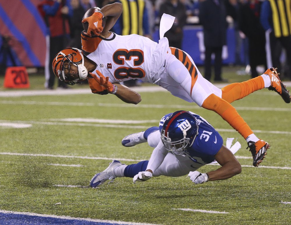 Bengals wide receiver Tyler Boyd dives over Giants cornerback Trevin Wade for a touchdown in the third quarter of New York's 21-20 win Monday in East Rutherford N.J