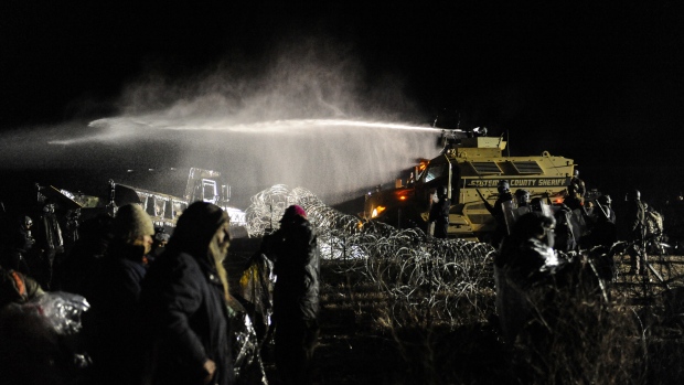 Police use a water cannon on protesters during a protest against plans to pass the Dakota Access pipeline near the Standing Rock Indian Reservation near Cannon Ball North Dakota