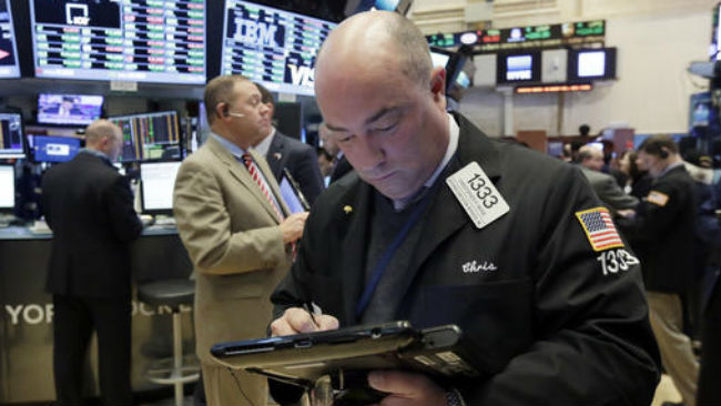 Trader Christopher Morie works on the floor of the New York Stock Exchange Monday Nov. 21 2016. U.S. stocks are rising in early trading as the price of oil jumps and energy companies move higher keeping indexes at record highs