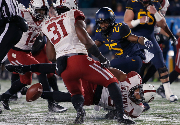 MORGANTOWN WV- NOVEMBER 19 Justin Crawford #25 of the West Virginia Mountaineers fumbles in the red zone against the Oklahoma Sooners in the first half