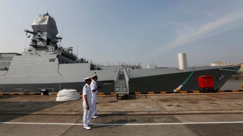 Indian Navy personnel stand next to the newly built INS Chennai India’s third indigenously designed guided missile destroyer ahead of its commissioning into the Navy in Mumbai India