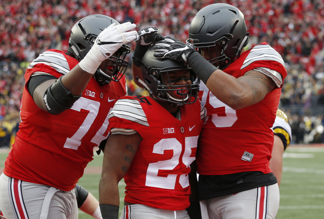 Ohio State running back Mike Weber center celebrates his touchdown against Michigan with teammates Jamarco Jones left and Luke Farrell during the second