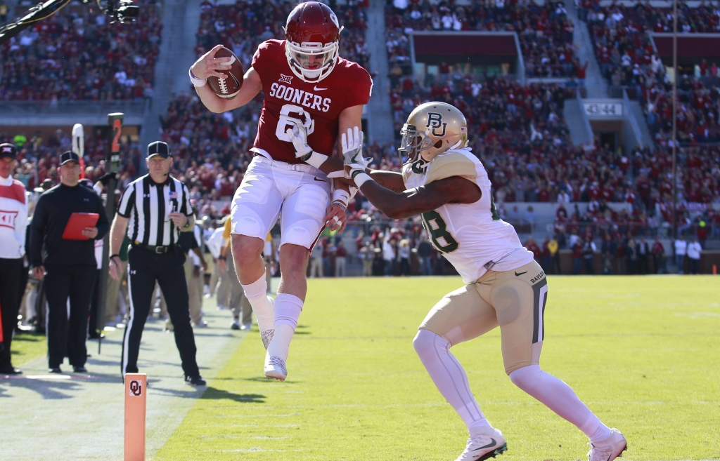 NORMAN OK- NOVEMBER 12 Quarterback Baker Mayfield #6 of the Oklahoma Sooners scores in front of safety Orion Stewart #28 of the Baylor Bears