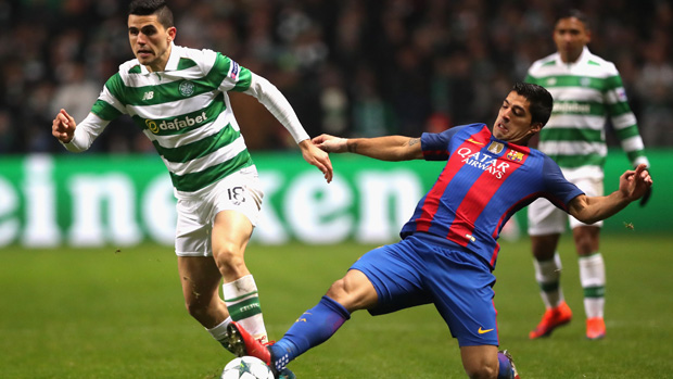 Tom Rogic is challenged by Barcelona superstar Luis Suarez in the UEFA Champions League