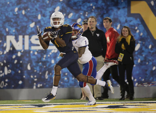 West Virginia cornerback Rasul Douglas intercepts a pass attended for Kansas wide receiver Rasul Douglas during the second half of an NCAA college football game in Mo