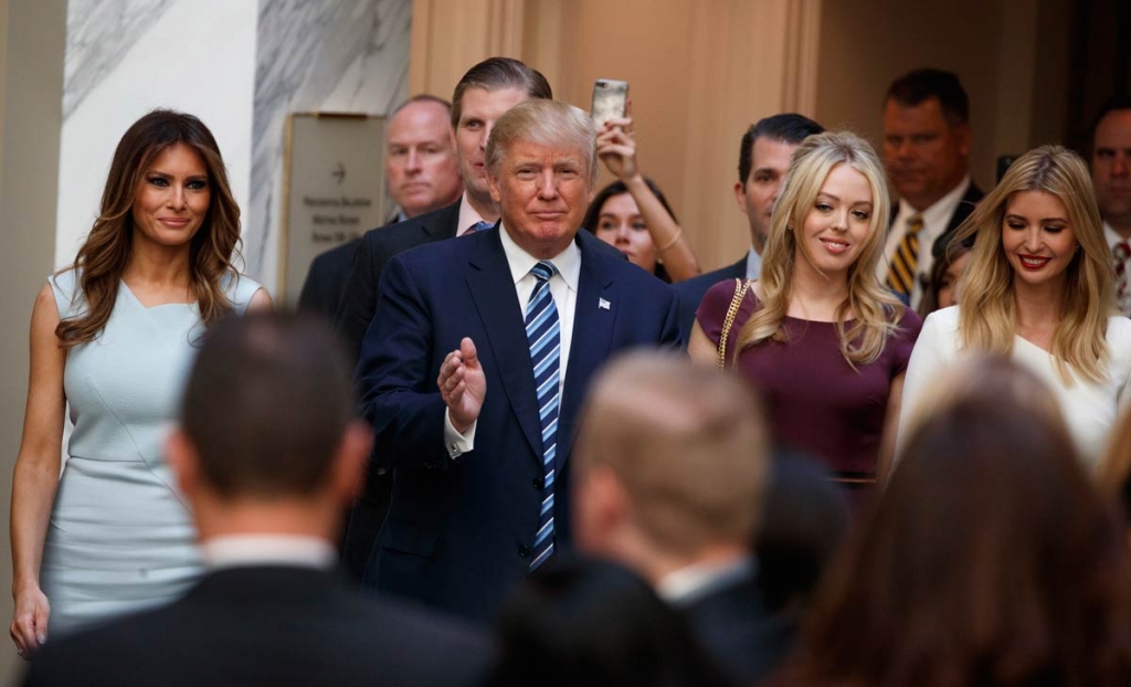 Republican presidential candidate Donald Trump accompanied by from left Melania Trump Eric Trump Donald Trump Jr. Tiffany Trump and Ivanka Trump arrives for a ribbon cutting ceremony during the grand opening of the Trump International Hotel Old Po