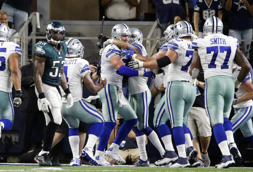 Philadelphia Eagles outside linebacker Nigel Bradham walks away as the Dallas Cowboys celebrate with tight end Jason Witten center left after Witten caught a pass in overtime in an NFL football game Sunday Oct. 30 2016