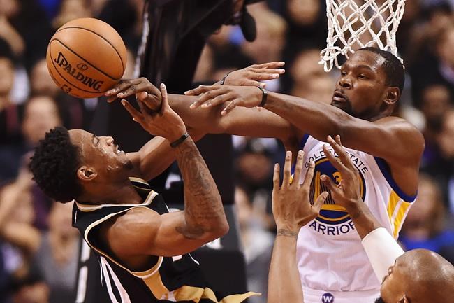 Toronto Raptors guard De Mar DeRozan is fouled by Golden State Warriors forward Kevin Durant during second half NBA basketball action in Toronto on Wednesday