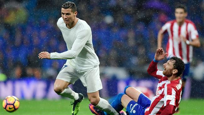 Sporting Gijon's Venezuelan defender Fernando Amorebieta falls down beside Real Madrid's Portuguese forward Cristiano Ronaldo during the Spanish league football match Real Madrid CF vs Real Sporting de Gijon at the Santiago Bernabeu stadium