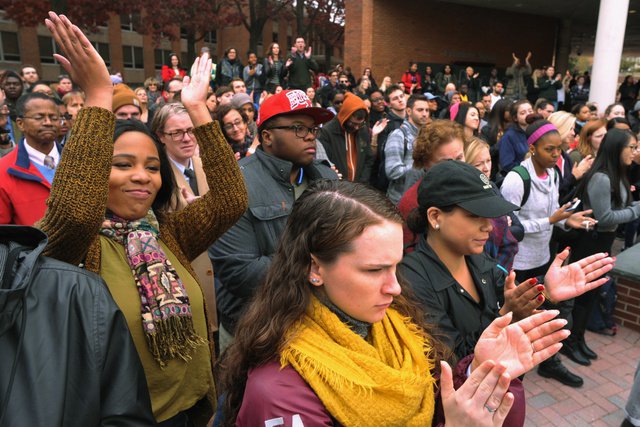 Alexandra Waller center front and Destiny Collins with arms raised in applause at left cheer speakers with other students during a midday student protest rally against President-elect Donald Trump at Towson University in Towson Md. Monday Nov. 14