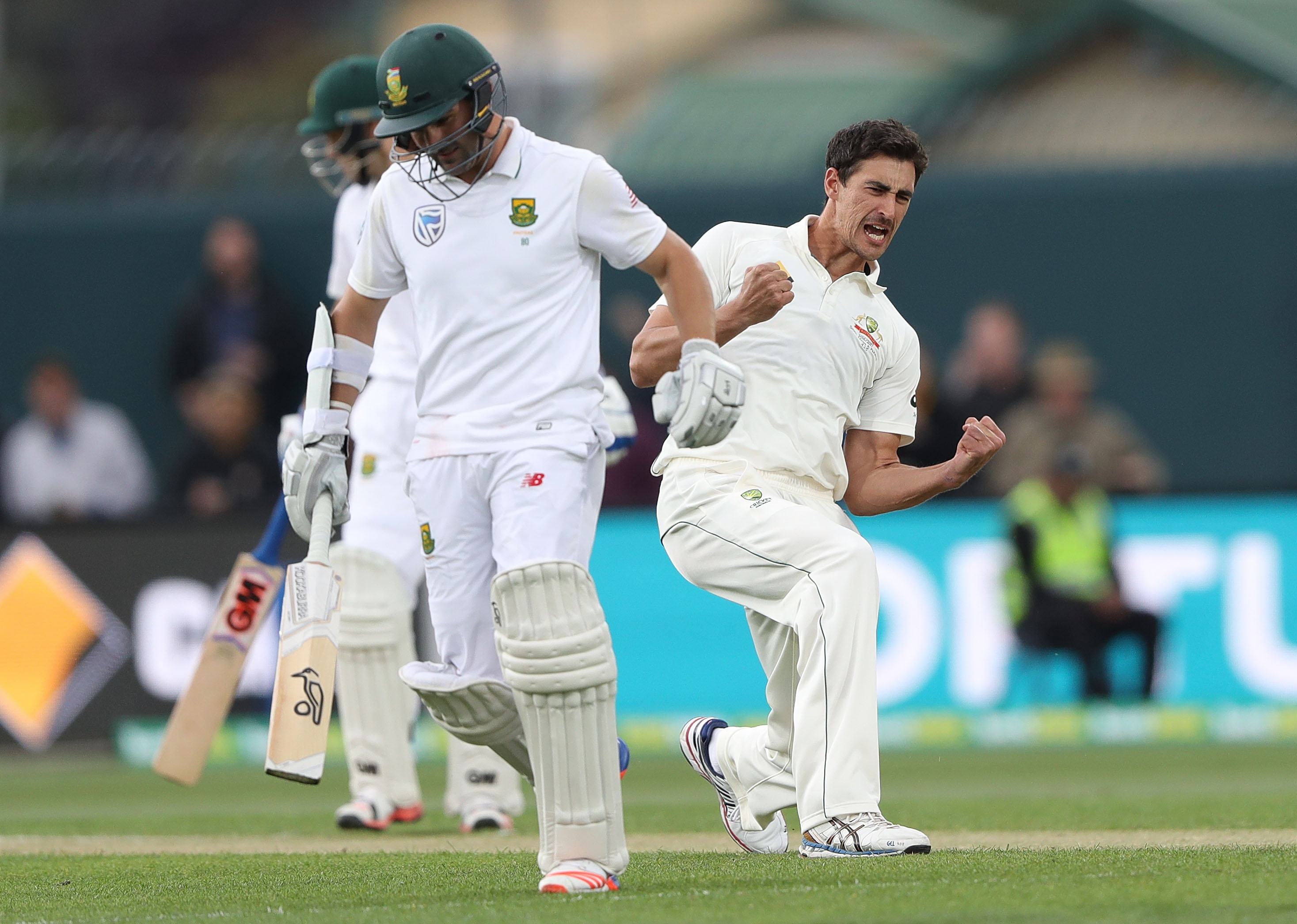 Mitchell Starc of Australia celebrates after taking the wicket of Dean Elgar