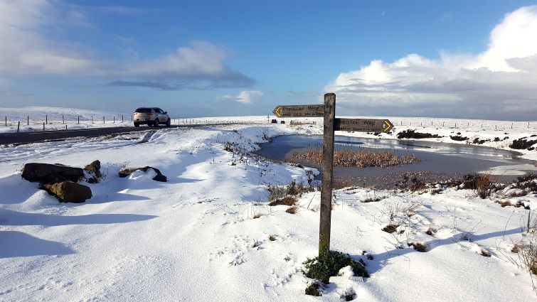 Snow settles along the summit of the Snake Pass on the A57 in the Peak District Derbyshire