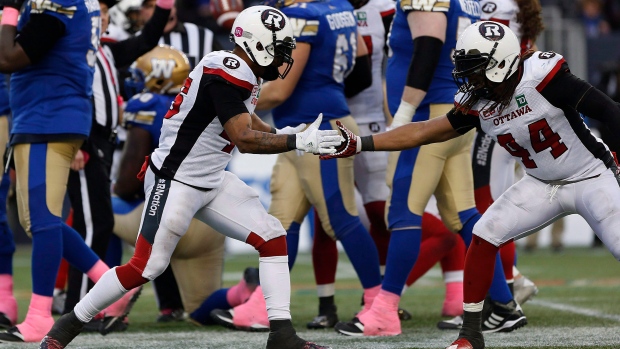 Ottawa Redblacks&#39 Damaso Munoz and Taylor Reed celebrate in a game against the Winnipeg Blue Bombers. Reed will meet his former team the Calgary Stampeders in the Grey Cup final on Sunday